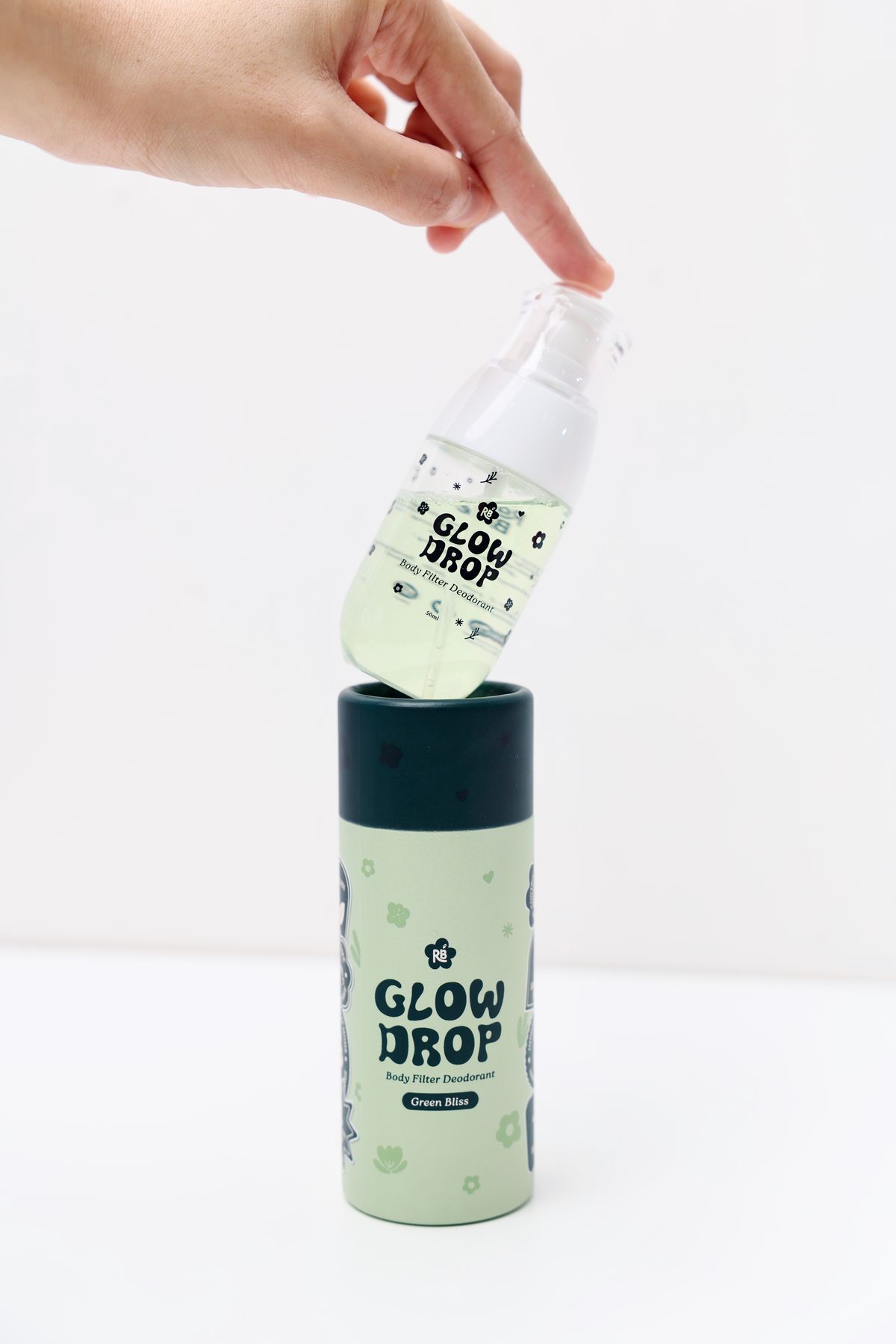 Hand lifting Glow Drop Green Bliss foam from tube